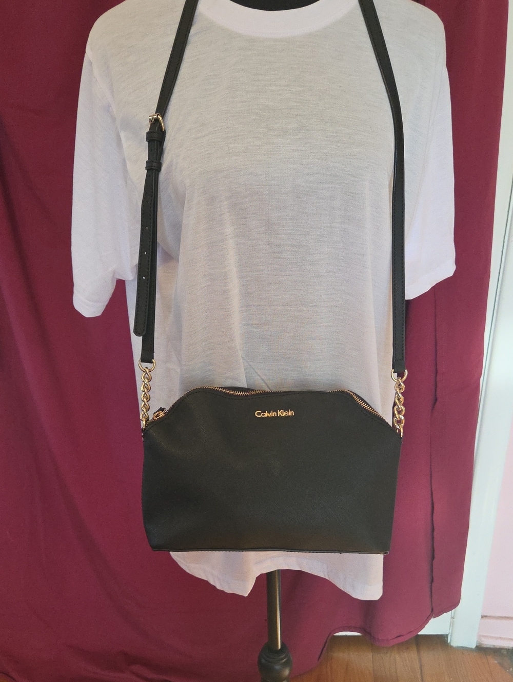 Calvin Klein Black Crossbody with Gold Chain Detail.